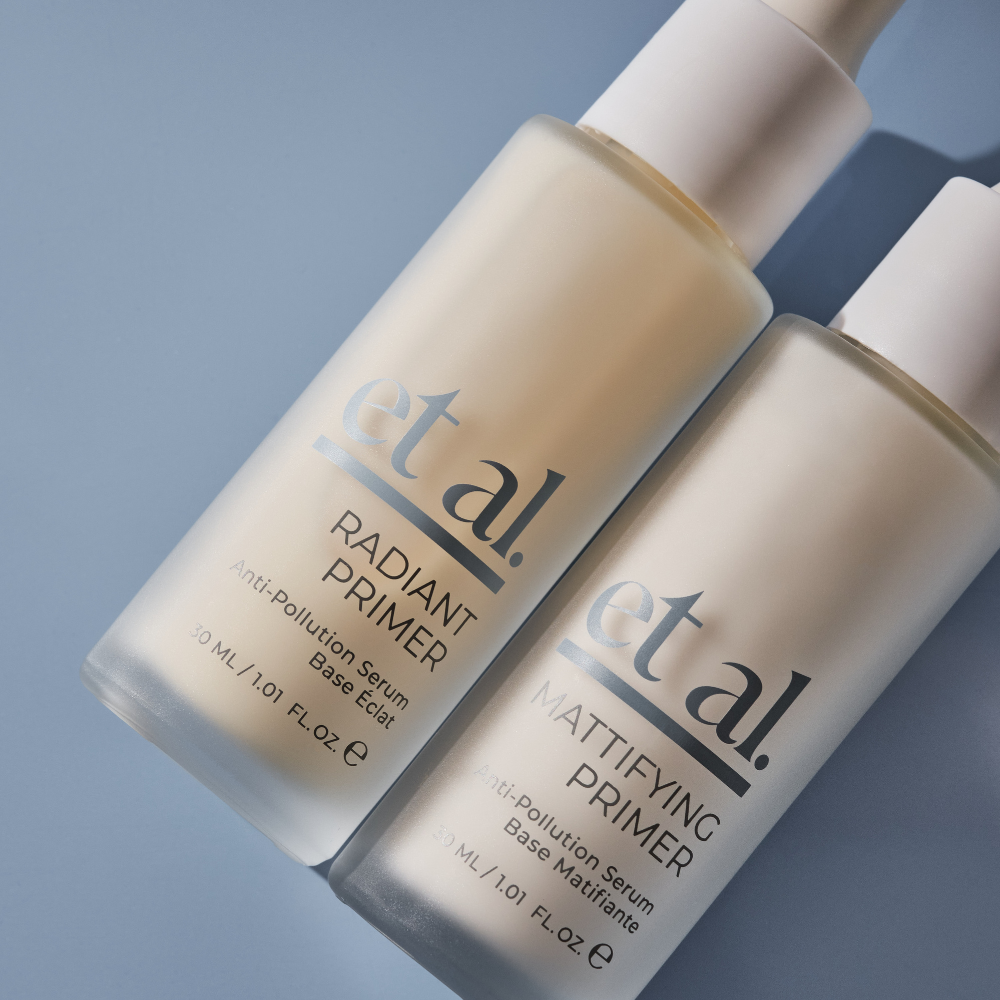 Two bottles of et.al. primer on a gradient blue background