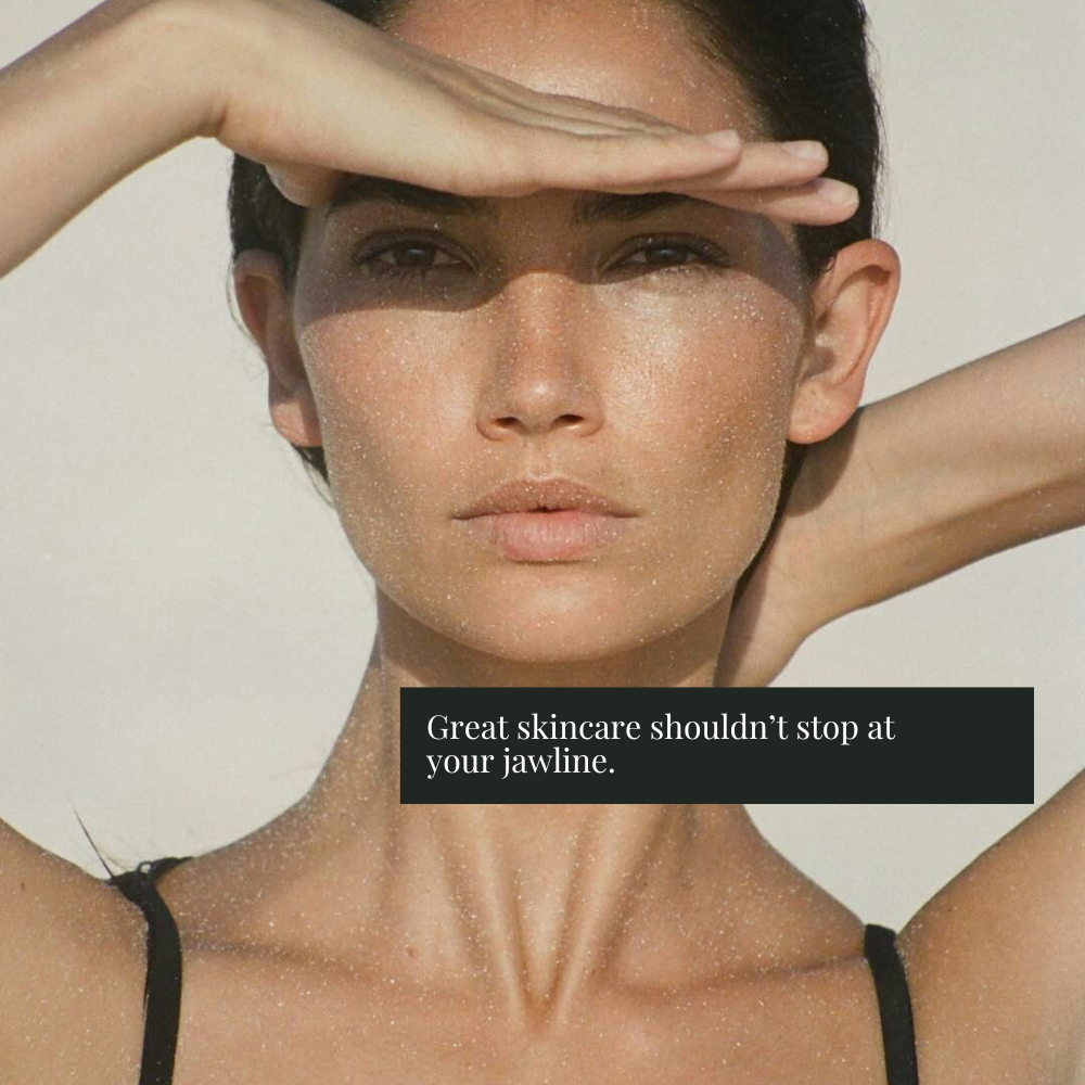 Close-up of a woman outdoors with her hands shielding her eyes from the sun, wearing a black bikini top. A black text box near the bottom reads, 'Great skincare shouldn't stop at your jawline.