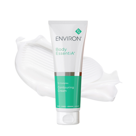 A white tube of Environ Body EssentiA Tri-Complex+ Contouring Cream with a green and white label. The tube contains 125ml of cream designed for cellulite treatment and skin firming. It features a powerful tri-complex of ingredients, including Intenslim™, Phytosonic™, and Vexyl™ SP, along with vitamins C and E. The product is intended to smooth, firm, and reshape the appearance of dimpled, lax, and unevenly textured skin, particularly on the arms, legs, buttocks, and jawline.