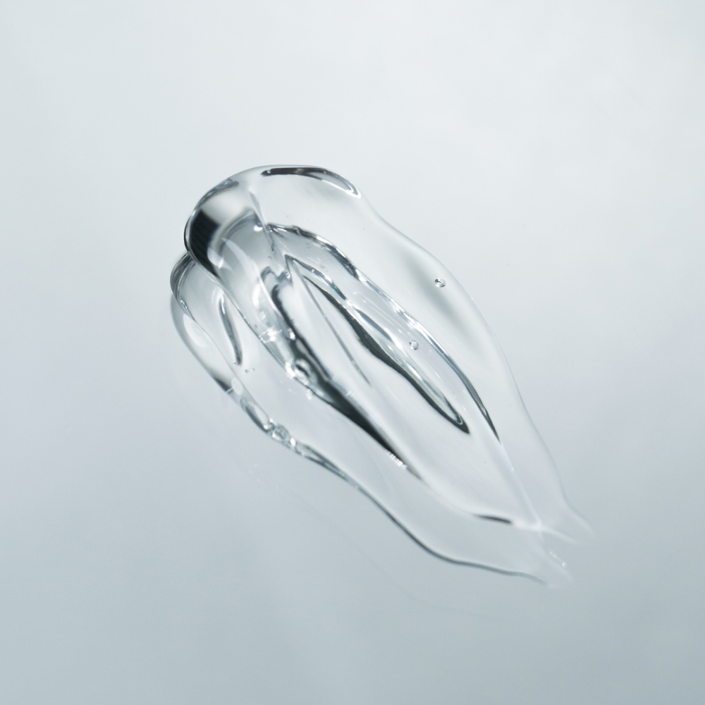 Clear gel-like substance on a light gray background