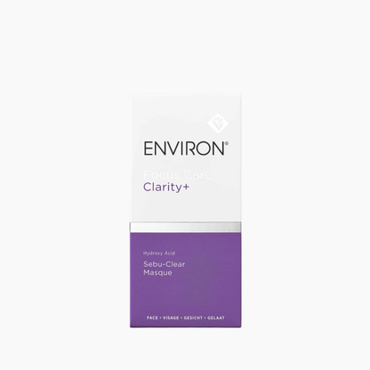 A rectangular skincare box for ENVIRON Clarity+ Sebu-Clear Masque, featuring a white top half with black and purple text, and a purple bottom half, centered on a light gray background.