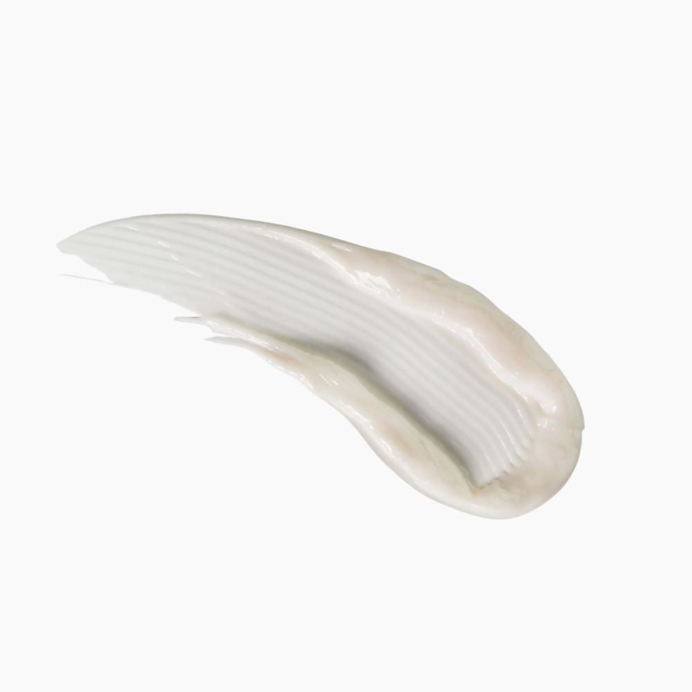 A thick, creamy white cosmetic smear showing a smooth, textured texture on a solid white background.