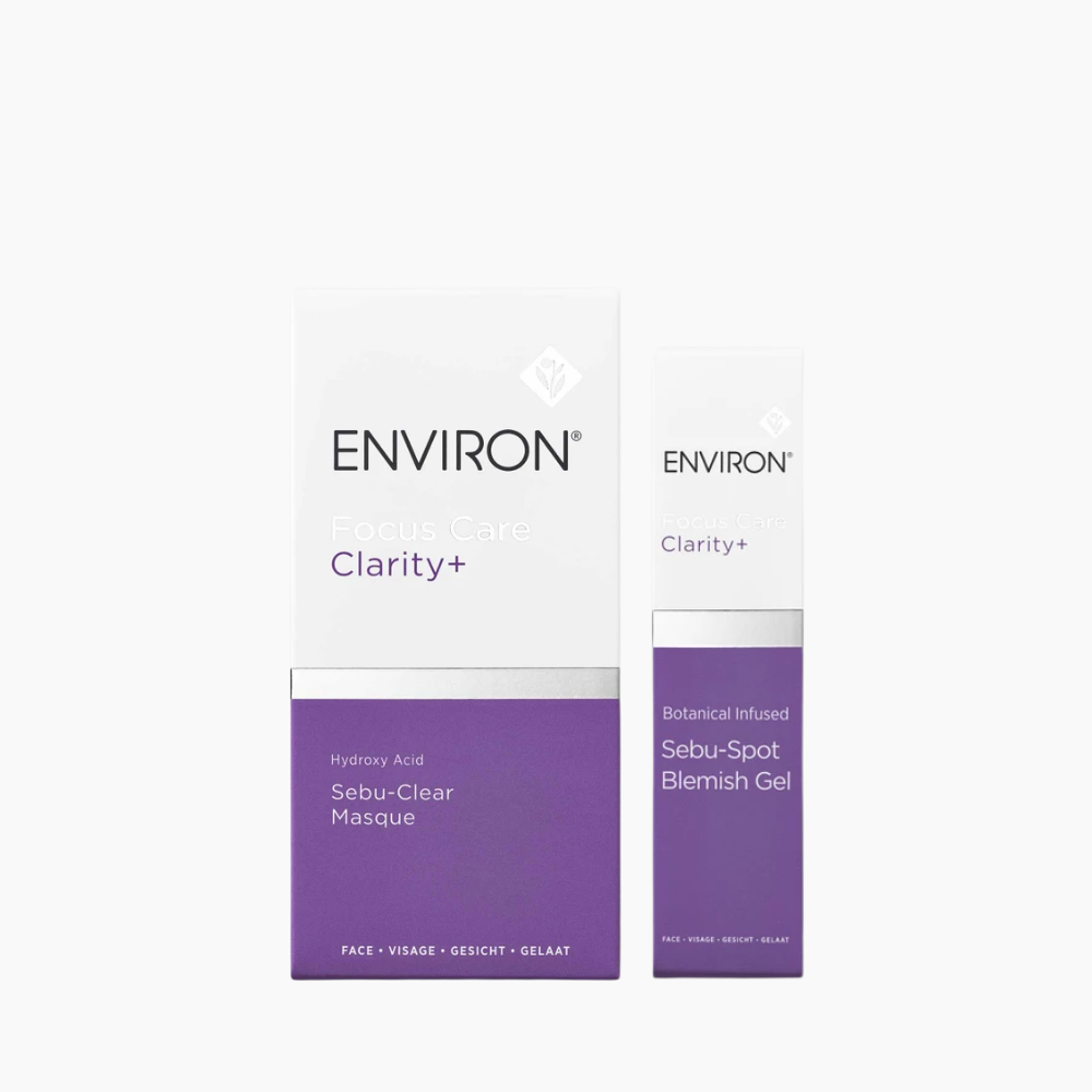 ENVIRON Focus Care Clarity+ skincare set featuring a white and purple box and a matching sebum-spot blemish gel tube on a light gray background.