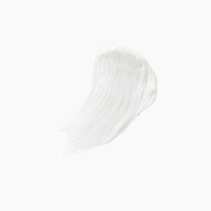 A textured swipe of white cream or lotion on a solid white background.