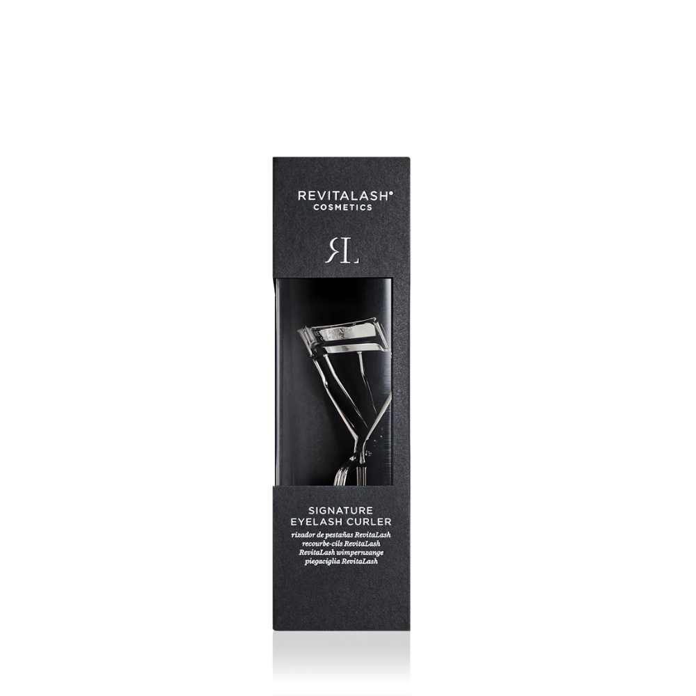 Revitalash Cosmetics Signature Eyelash Curler in its black packaging box, shown against a plain white background.