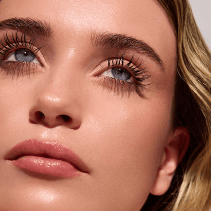 Close-up of a woman's face with emphasis on her eyes and eyelashes.