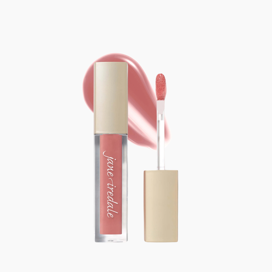 A clear tube of Jane Irdale liquid lipstick with a beige cap, shown next to its applicator wand and a soft pink product swatch on a clean white background.