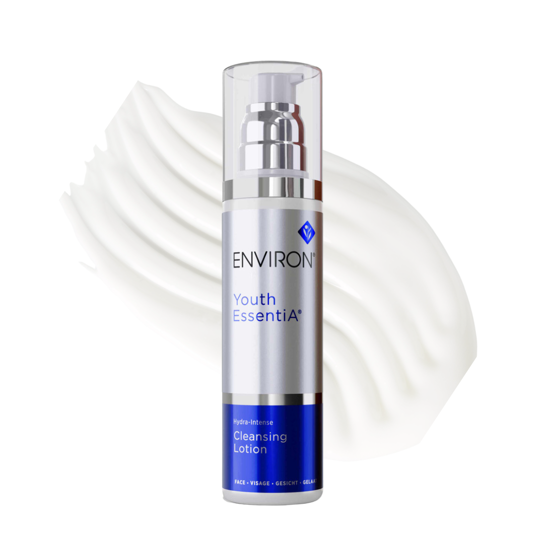 Environ Youth EssentiA Hydra Intense Cleansing Lotion in a sleek blue and white 200ml bottle. The packaging prominently features the Environ logo and product name. This luxurious cream cleanser is designed to remove makeup and impurities while maintaining the skin's natural pH balance and moisture levels, suitable for all skin types, especially dry, sensitive, and rosacea-prone skin.